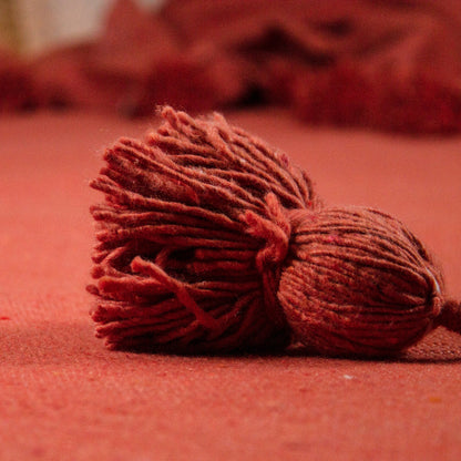 coperta in cotone con pompom