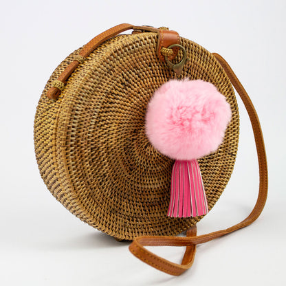 Borsa rattan rotonda a tracolla con pom pom